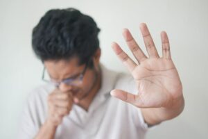 Selective Focus Photo of Coughing Man's Hand